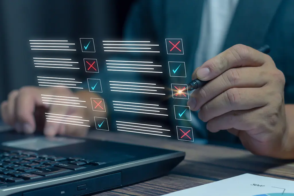 A man is using a laptop to perform an SEO audit.